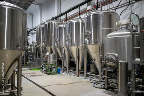 Cuadro en lienzo Large stainless steel fermentation tanks aligned inside modern industrial brewer