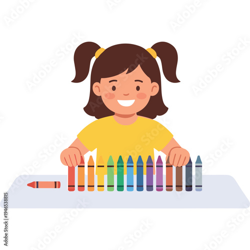 A girl happily arranges colorful crayons on a table indoors.