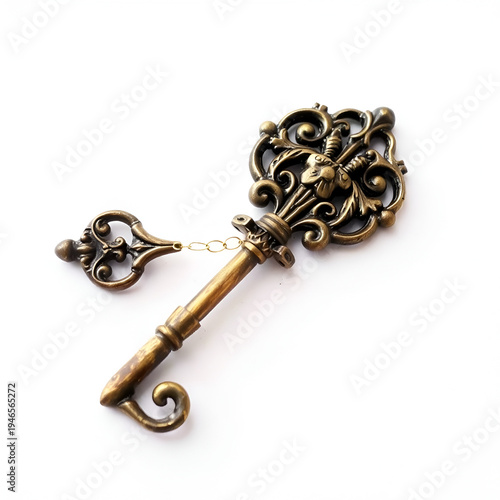 An intricately designed ornate vintage key with a slightly tarnished metallic surface, lying on a white background.