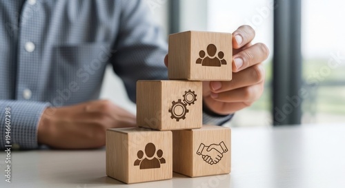 Businessman building a structure with wooden blocks representing teamwork and partnership