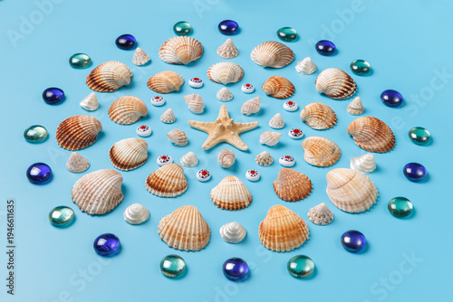 Canvas Print A pattern of exotic shells, starfish and glass beads on a blue background