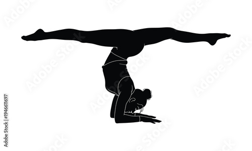 Silhouette of woman performing difficult yoga pose on hands with legs extended