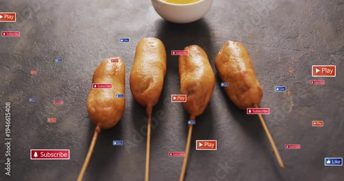 4 corn dogs staying on tabletop on play, subscribe or play badges clustering then fading for ads