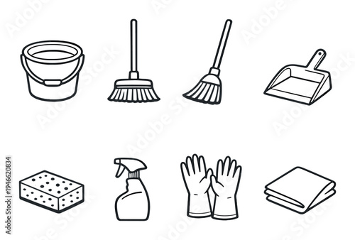 Household cleaning utensils arranged on gray background