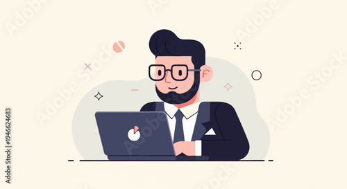A smiling, bearded man in a suit and glasses works on a laptop