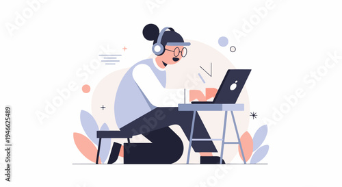 A person wearing headphones types on a laptop at a desk with a stool