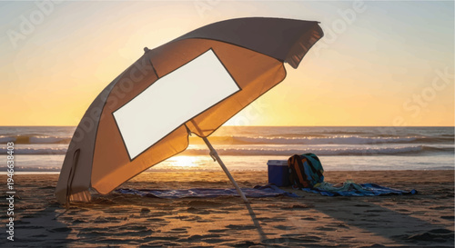 A lone umbrella stands on a beach at sunset, with a towel and bag nearby.