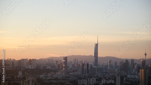 Canvas Print Kuala lumpur city skyline featuring prominent super tall skyscraper and communications tower at sunset