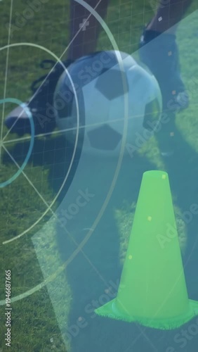 Right foot touching ball, soccer trainee nudging and dragging ball around cone, practicing control