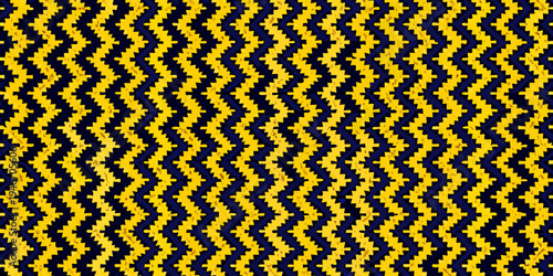 A vibrant yellow and navy blue zigzag pattern fills the entire frame