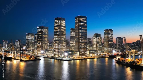 Wallpaper Mural Illuminated skyscrapers and cargo ships reflecting in the harbor water at dusk during a beautiful sunset Torontodigital.ca