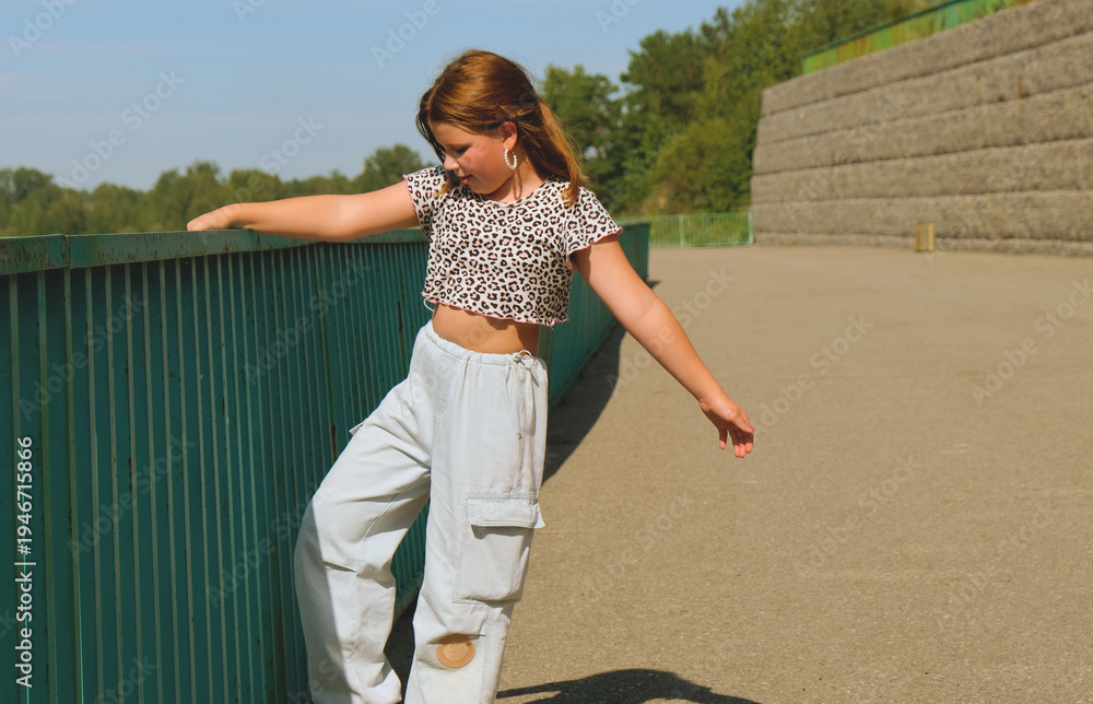 Obraz premium Happy girl enjoying walking, dancing, jumping. Freedom and carefree. Happy childhood. Activity summer vacations. Lifestyle photography