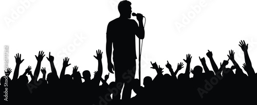 Silhouette of a singer performing on stage with a cheering crowd