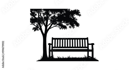 A park bench rests beneath a leafy tree in stark silhouette
