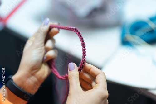 Young woman training to knit at knitting course