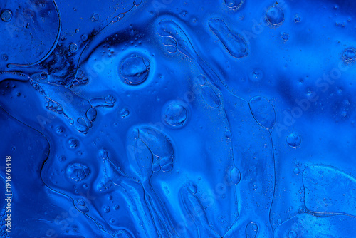 Intense blue liquid bubbles in water macro abstract ocean texture