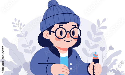 A smiling person in a blue beanie, glasses, and jacket holds a colorful object amidst plants