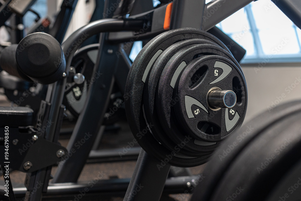 Fototapeta premium Gym equipment weights and various exercise tools, creating environment for effective workouts and strength training. Modern and clean gym interior with sport and fitness equipment, fitness center inte