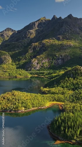 Wallpaper Mural Stunning aerial view of Lofoten islands mountains, vertical shot of Norway fjord landscape. High angle view of Lofoten peaks and ocean. Norwegian mountain landscape with pristine water and trees Torontodigital.ca