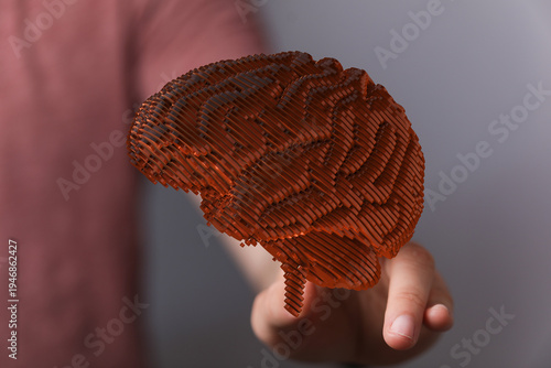 Hand holding a 3D brain rep...