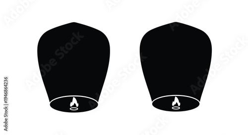 Two kongming lanterns with small flames stark black silhouette