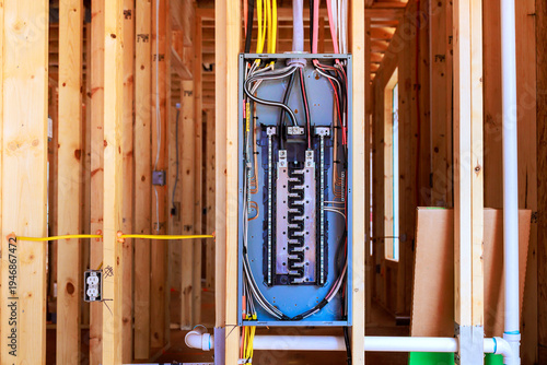 фотографія Electrical panel installation in new home under construction with exposed framin