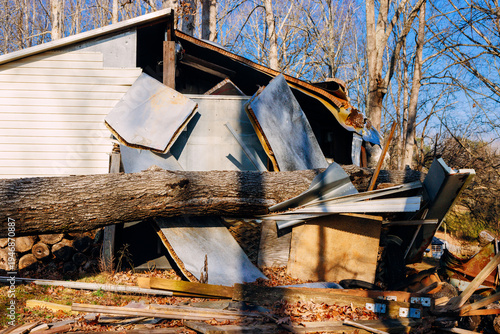 Tree falls on building in wooded area causing damage destruction