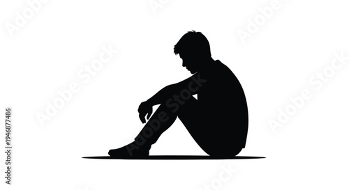 A solitary figure sits in contemplation depicted as a dark silhouette