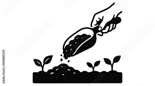 Hand spreading compost on new plants for growth and nourishment