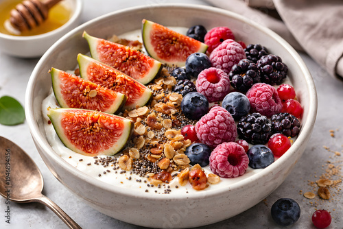 Healthy breakfast bowl  with yogurt, fresh figs and frozen berries