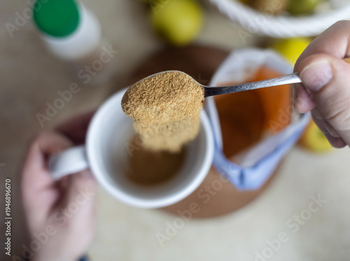 Wallpaper Mural Person adding apple fiber powder to a glass of yogurt, surrounded by fresh apples and walnuts. Healthy prebiotic supplement for gut health, digestion and weight management. Torontodigital.ca