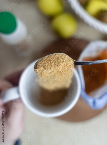 Wallpaper Mural Person adding apple fiber powder to a glass of yogurt, surrounded by fresh apples and walnuts. Healthy prebiotic supplement for gut health, digestion and weight management. Torontodigital.ca