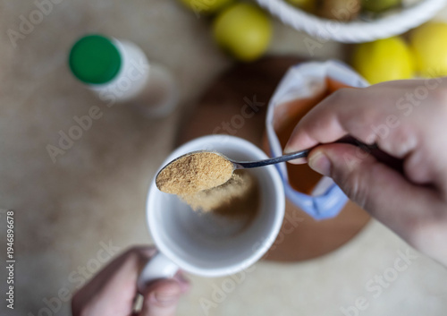 Wallpaper Mural Person adding apple fiber powder to a glass of yogurt, surrounded by fresh apples and walnuts. Healthy prebiotic supplement for gut health, digestion and weight management. Torontodigital.ca