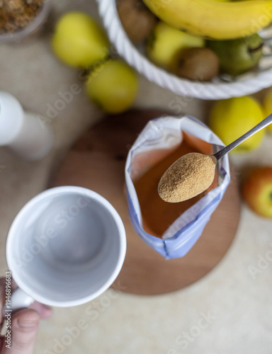 Wallpaper Mural Person adding apple fiber powder to a glass of yogurt, surrounded by fresh apples and walnuts. Healthy prebiotic supplement for gut health, digestion and weight management. Torontodigital.ca