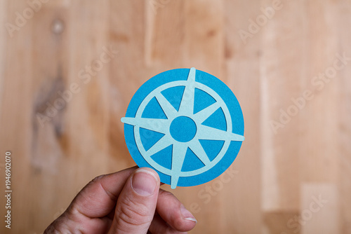 Blue compass in hand, signi...