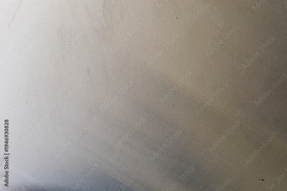 Obraz premium Abstract background featuring a subtle gradient on a textured metallic surface, ideal for design templates and digital u