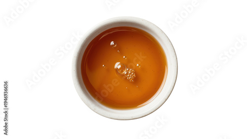 Cuadro en lienzo Isolated small white ceramic bowl containing sweet golden honey or maple syrup with bubbles