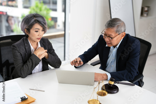 Lawyer and an attorney discuss the contract. A successful businessman reviews the agreement. Concept of business deal and legal consultation.