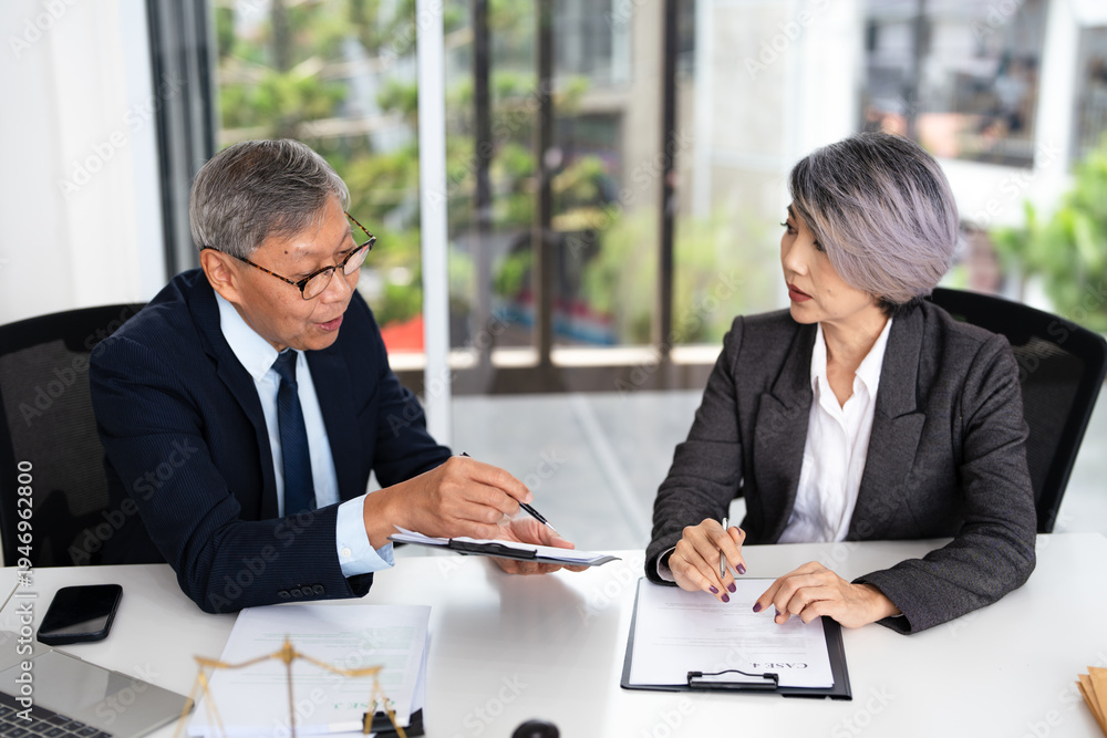 Fototapeta premium Lawyer, solicitor or barrister, supervisor talk to analyse case report, discussing paper policy terms conditions with client, conduct lawsuits document