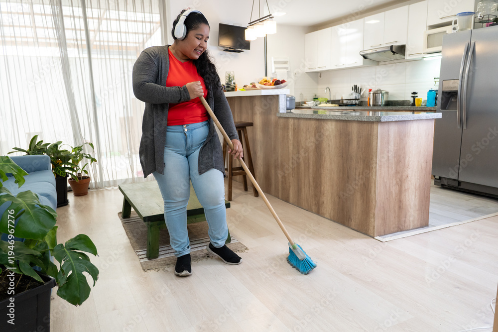 Fototapeta premium Woman sweeping floor a happy home lifestyle
