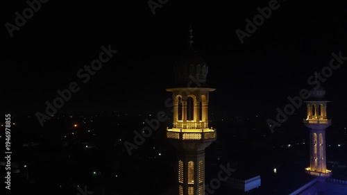 Historic Mosque with Ramadan Lights
Beautiful Night Aerial View - Drone orbiting a tall minaret of an illuminated mosque - 4K video