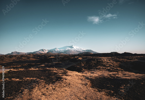 Volcanic landscape with distant snow-capped mountains in Iceland