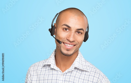 Smiling handsome businessman wearing headset looking at camera