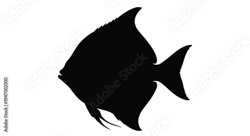 A striking black silhouette of a tropical fish swimming gracefully