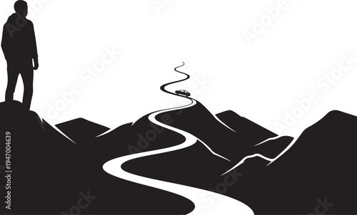 Silhouette of a person overlooking a winding road through mountainous terrain