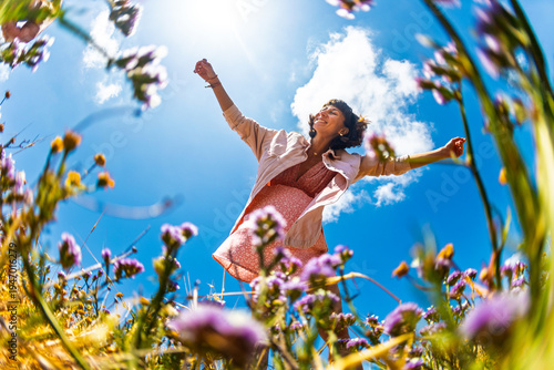Summer lifestyle portrait of a beautiful young brunette in a summer pink dress. Romantic mood.