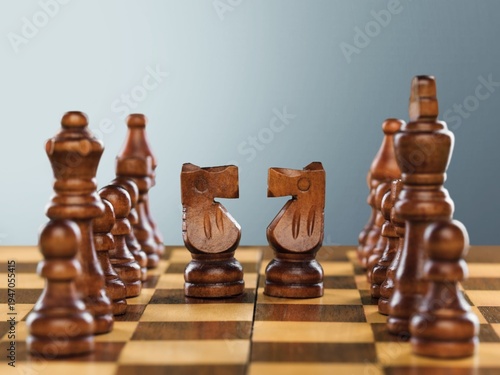 Wooden chess figures on a classic chessboard