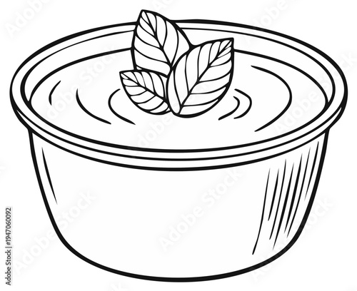 Bowl of soup with three basil leaves