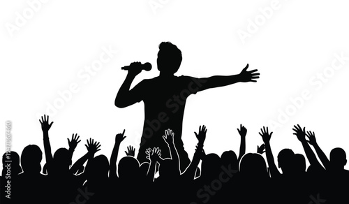 A silhouette of a male singer performing on stage in front of a cheering crowd at a music concert