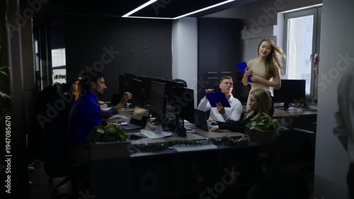 Wallpaper Mural Business professionals are actively working and collaborating at their desks in a modern office. Team members engage in discussions and tasks, fostering productivity and teamwork. Torontodigital.ca